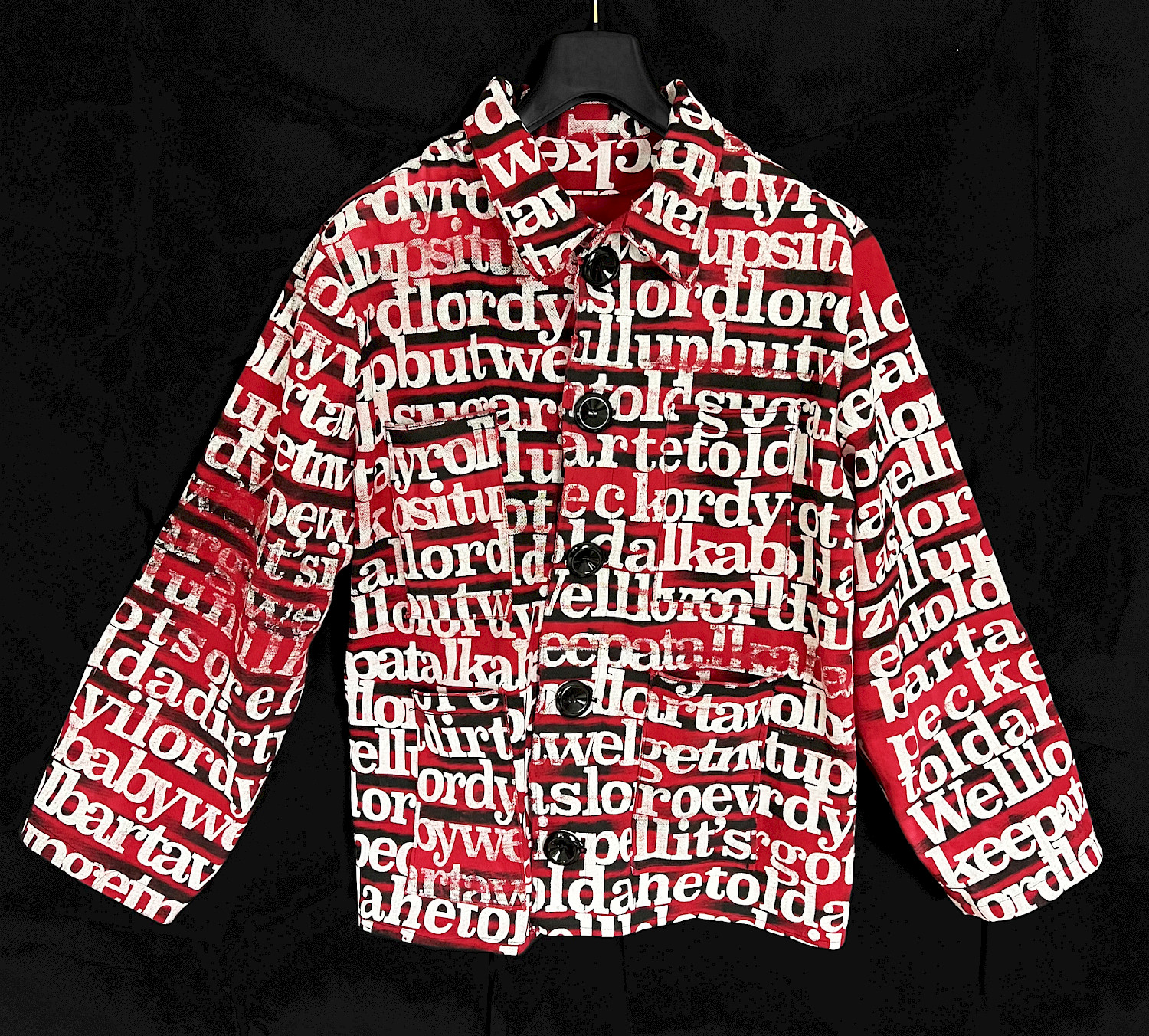 ‘When I Rise’ is a visual interpretation of the music piece “Early in the Mornin’” by Alan Lomax. The musics data has been transformed into a screen-print on fabric, crafted into a work-wear jacket. The images represent the sound of the lyrics, not their literal content, with a distorted black layer obscuring the actual words. ‘When I Rise’ is a visual interpretation of the music piece “Early in the Mornin’” by Alan Lomax. The musics data has been transformed into a screen-print on fabric, crafted into a work-wear jacket. The images represent the sound of the lyrics, not their literal content, with a distorted black layer obscuring the actual words.